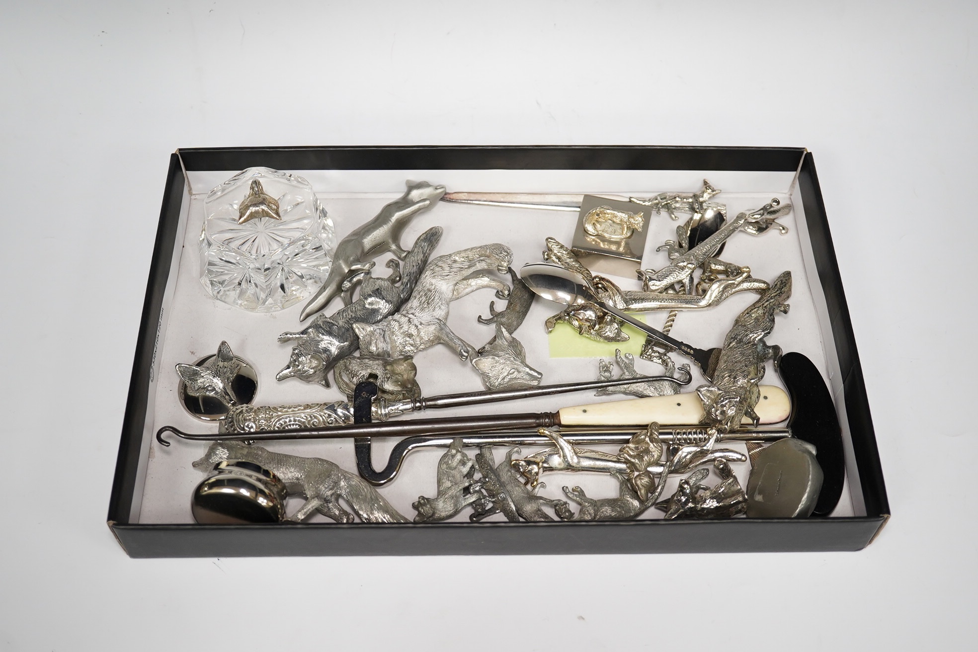 A collection of silver plated, pewter and white metal models of foxes, glass paperweight, button hooks, etc. Condition - mostly fair